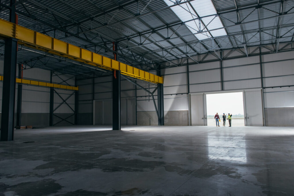 empty warehouse with workers in doorway 1200x801