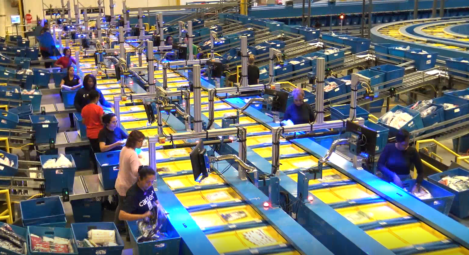 Group of warehouse employees sorting packages