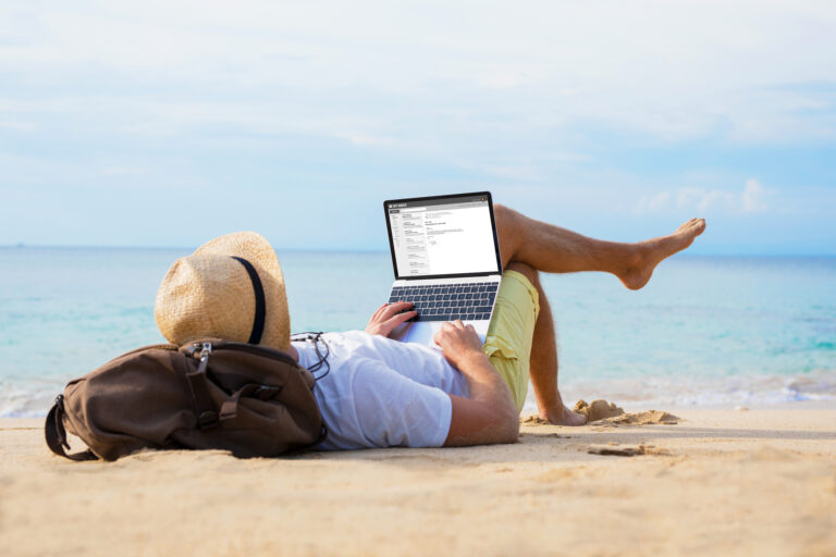 business man on a laptop on the beach