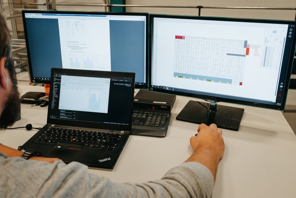 Element Logic specialist using laptop and two monitors