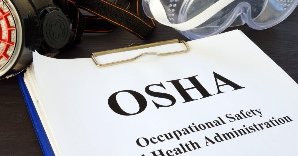 Pile of documents with Occupational Safety and Health Administration OSHA